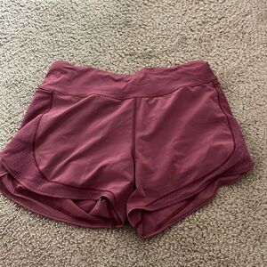 Mauve Lululemon shorts with mesh-detailed side pockets